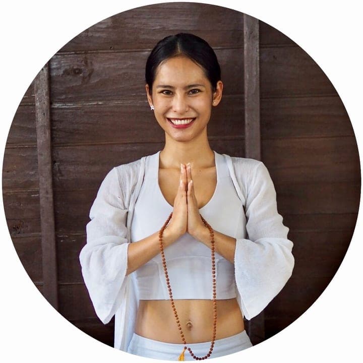 Nicha smiling with hands in prayer — certified yoga teacher in Chiang Mai